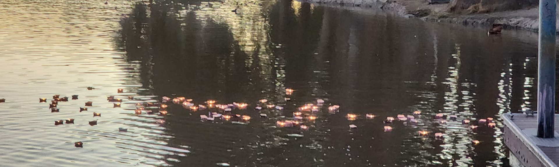 Picture of lake at sunset with paper boats